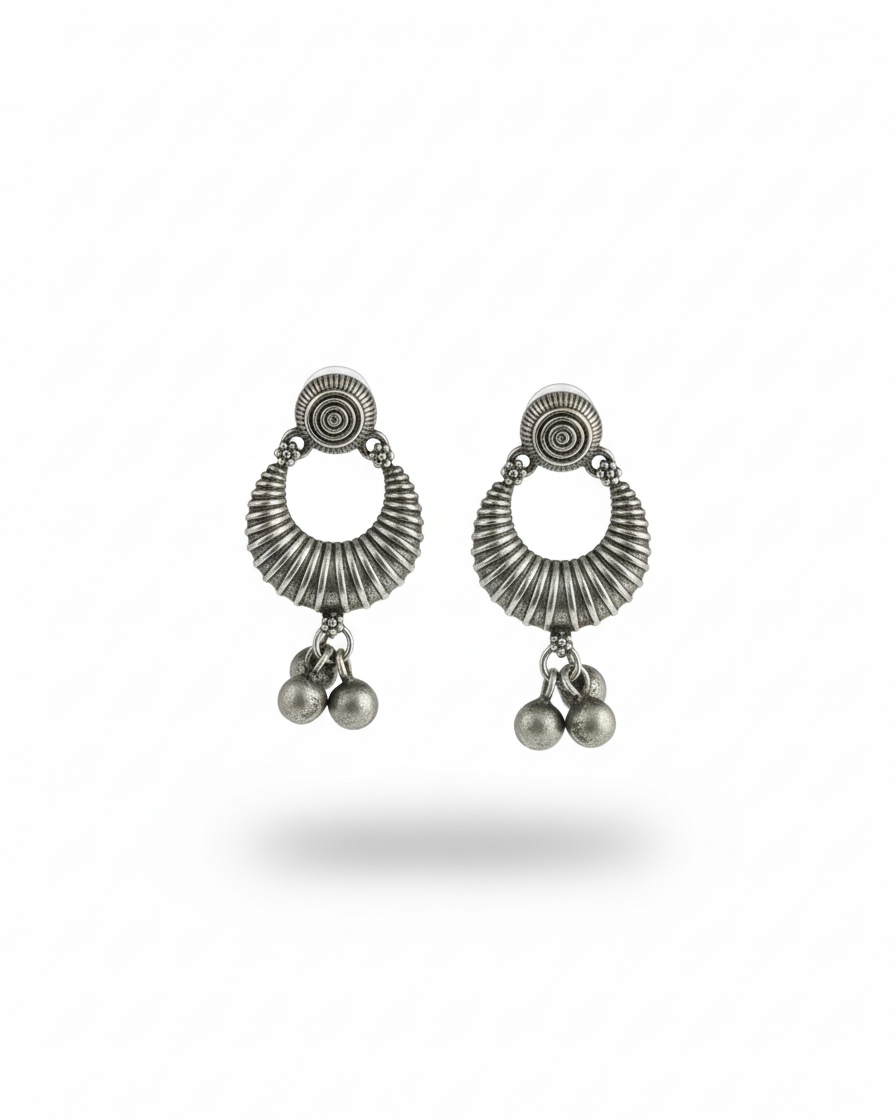 Pair of silver earrings with circular designs and dangling beads on a white background