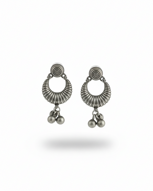 Pair of silver earrings with circular designs and dangling beads on a white background